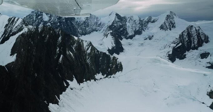 Aerial view of the snow-covered peaks and glaciers of Mount McKinley seen from a small plane in Denali Borough, Alaska, United States.