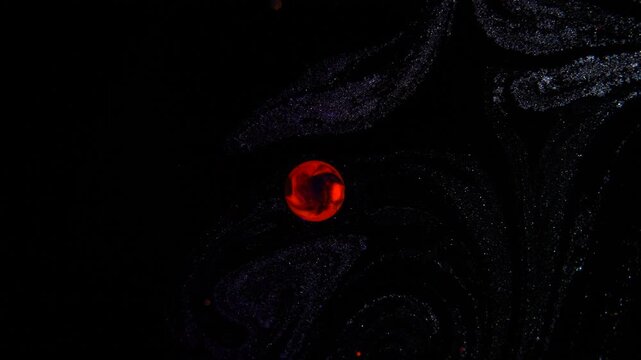 An abstract drop resembling a red planet in the starry cosmos.