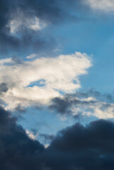 Obraz premium Dark cloud masses frame a narrow blue opening high above 