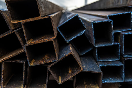 Industrial stacked metal pipes close up