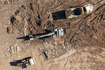 Construction site with heavy machinery working on land preparation © Iryna