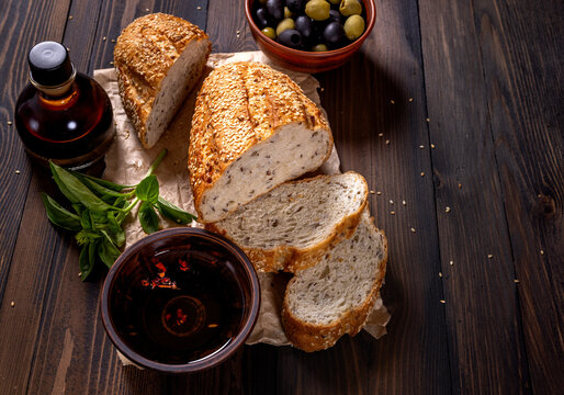 Fresh baked bread with olive oil, balsamic vinegar, olives