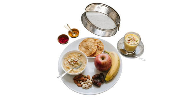 Healthy breakfast plate with oatmeal porridge fresh banana red apple nuts and a cup of golden turmeric milk drink