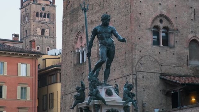 Fountain of Neptune with bronze statue and surrounding medieval architecture in Bologna old town, Emilia-Romagna, Italy. Renaissance sculpture, Italian public art, European city tourism