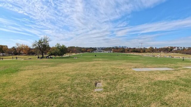 Washington DC park landscape features grass, autumn trees and paths in 4K video.
