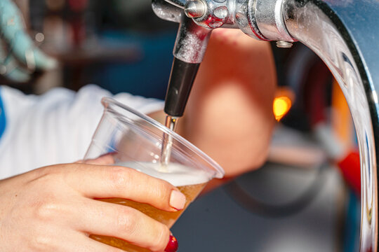A professional beer draft machine pouring fresh lager into glass steins. Perfect for Oktoberfest festival concepts, pub bar equipment, and traditional German beer celebrations.

