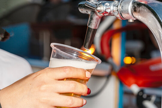 A professional beer draft machine pouring fresh lager into glass steins. Perfect for Oktoberfest festival concepts, pub bar equipment, and traditional German beer celebrations.

