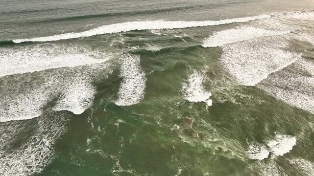 Aerial view of Pacitan Rip Current showing powerful ocean waves and turbulent water patterns off the coast of Pacitan, East Java, Indonesia.