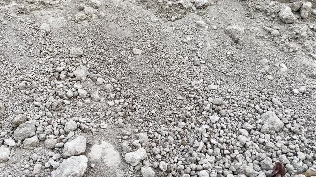 Top view of dry rocky soil texture background with rough gravel and stones