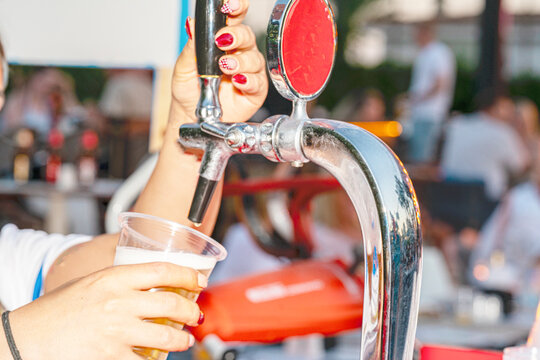A professional beer draft machine pouring fresh lager into glass steins. Perfect for Oktoberfest festival concepts, pub bar equipment, and traditional German beer celebrations.

