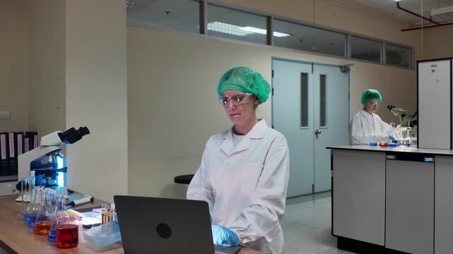 Laboratory room. Female scientists conducting laboratory research with colorful chemical samples. Using test tubes flasks and microscopes for scientific analysis and experimentation. Bio or chemical