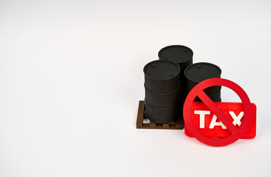 Oil barrels with crossed TAX sign representing petroleum tax exemption isolated on white background.
