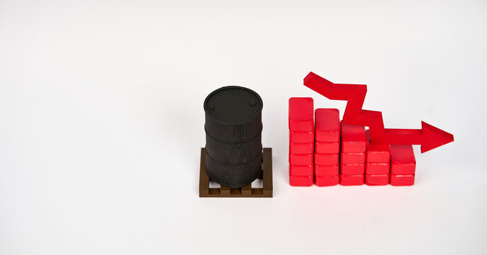 Oil barrel beside a descending block chart and downward arrow symbolizing falling petroleum prices isolated on white background.

