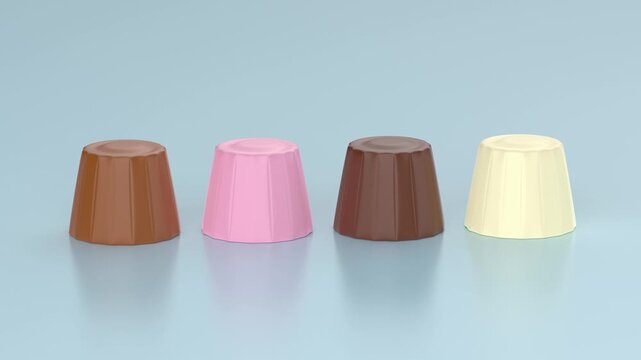 Milk, pink, dark and white chocolate pralines on light blue background