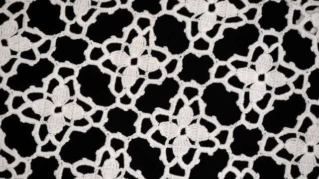 Crochet lace seamless pattern background, crocheted Grandma's Doily, detail of hand-crocheted embroidery, tablecloth, napkin isolated on black. Craft art, vintage linen rotating backdrop. Flat lay 