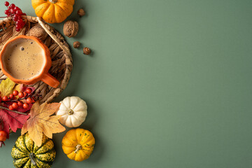 Obraz premium Autumn coffee with small pumpkins, fall leaves and nuts on green background for Thanksgiving with empty place for text and promo