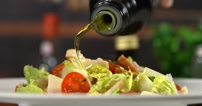 Olive oil pouring onto caesar salad slow motion 1000 fps