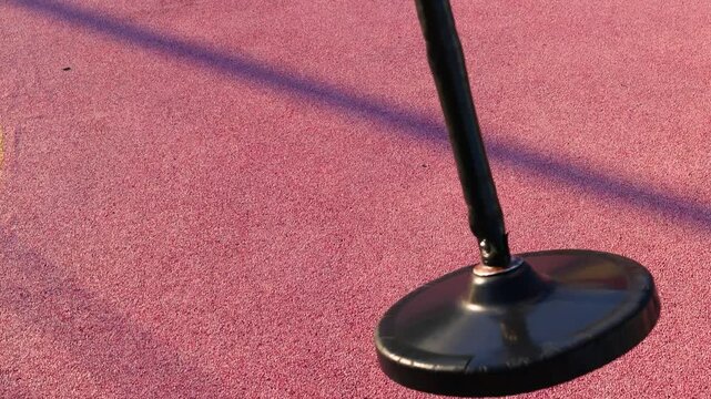 Swing post casts long shadow on padded play surface