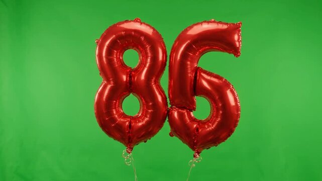 Red Foil Number 86 Balloons Floating On Green Screen
