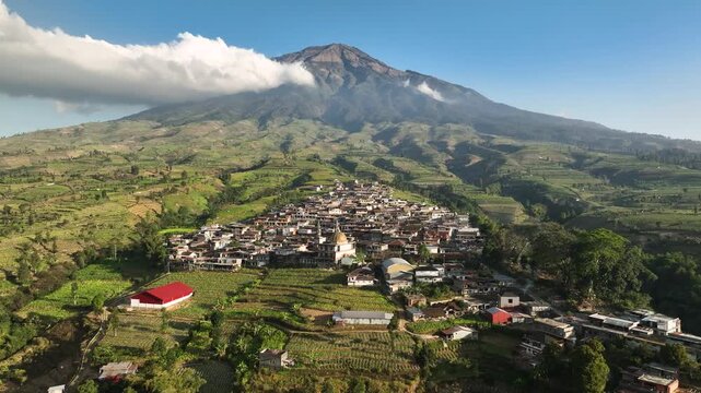 Aerial view of Kruwisan Village nestled among lush terraced fields and mountains in Kledung, Central Java, Indonesia.