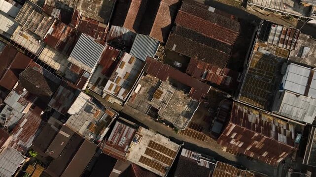 Aerial view of Kruwisan Village rooftops with rustic metal sheets and traditional structures in Kledung, Central Java, Indonesia.