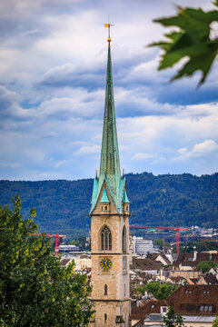 Historic church spires above tiled old town roofs, Zurich, Switzerland cityscape