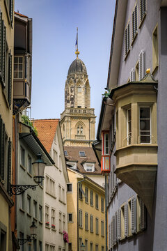 Grossmunster church tower framed by historic buildings in Zurich, Switzerland