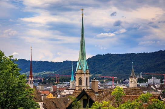 Historic church spires above tiled old town roofs, Zurich, Switzerland cityscape