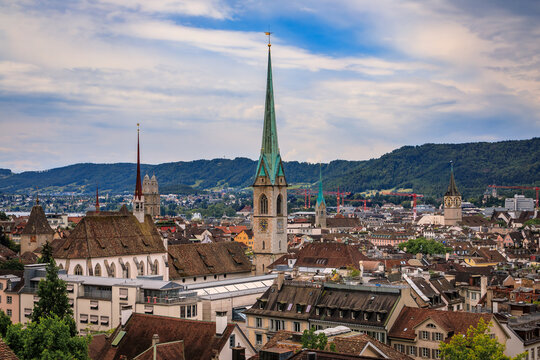 Historic church spires above tiled old town roofs, Zurich, Switzerland cityscape