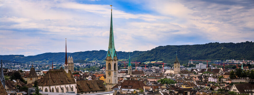 Historic church spires above tiled old town roofs, Zurich, Switzerland cityscape
