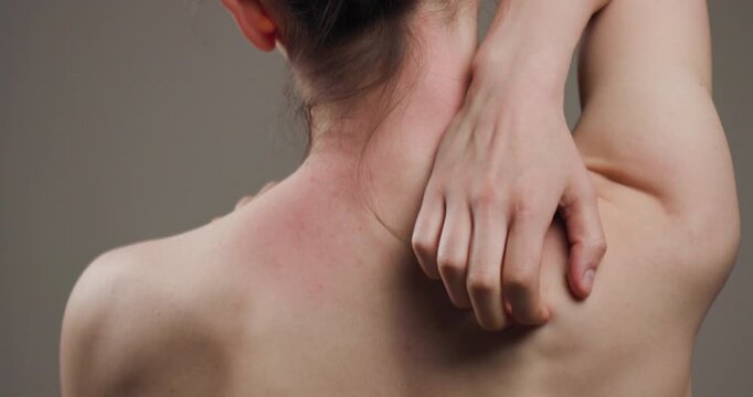 Close-up view of a woman massaging her shoulder to relieve pain