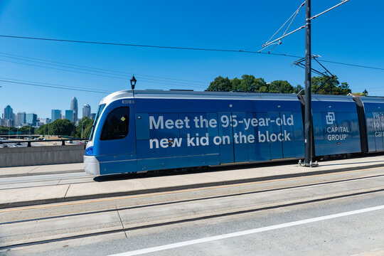 Charlotte Area Transit System, CATS, Lynx Gold Line Streetcar crosses the Central Ave bridge with a view of the Uptown Charlotte skyline