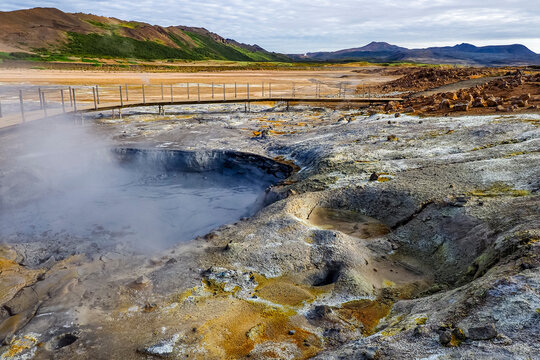 Hverir, a sulfur-smell active geothermal field. Namafjall, Reykjahlid, Iceland. Surreal area with bubbling or boiling mud pots, steaming vents, volcanic activity, vibrant mineral colors and fly lands.