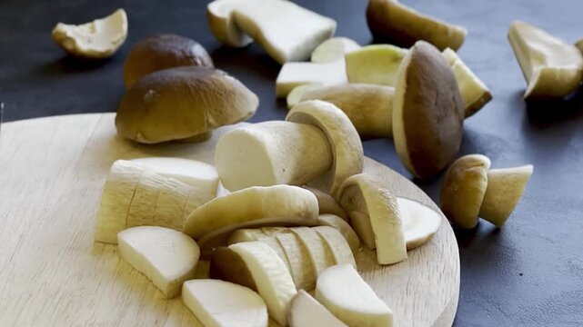 Close up of fresh cutted boletus mushroom on wooden cutting board 