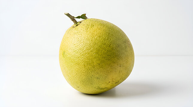 One whole greenish yellow pomelo citrus large round coarse porous with short woody stem small green leaf, fresh glossy on clean white surface soft shadow minimalist