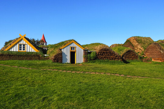 Ancient Icelandic cut turf houses. Glaumbaer, typical turf farm - historical site, open-air folk museum, examples life from 11th ct. Lutheran church Glaumbaejarkirkja. Varmahlid, Skagafjordur, Iceland