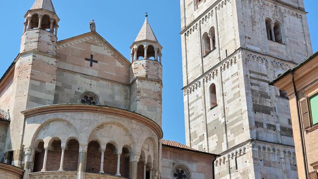 The majestic Ghirlandina bell tower rises above Modena cathedral, San Geminiano, complementing the historic beauty of Modena's charming downtown architecture of Modena city in Italy