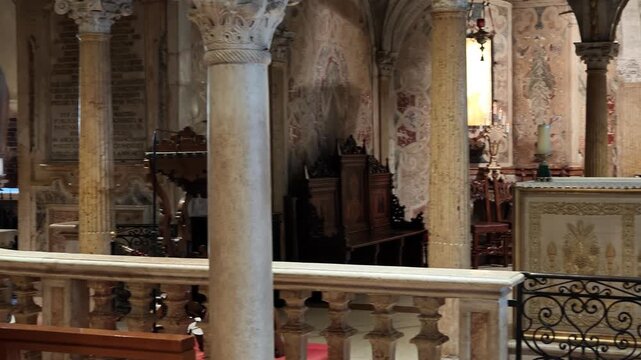 Tranquil view of the historic crypt in Modena cathedral, featuring architectural columns, arches, and softlylit benches for contemplation of Modena city in Italy