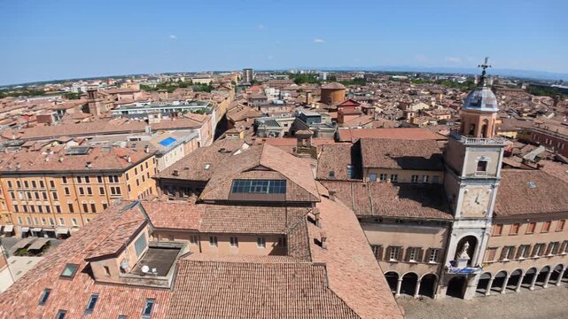Stunning aerial panorama of Modena's historic downtown, captured from the iconic Ghirlandina bell tower overlooking the vibrant Piazza Duomo square of Modena city in Italy