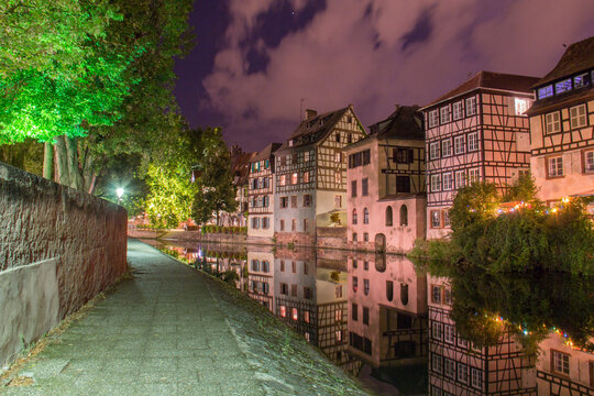 Petite France Strasbourg at night with illuminated half-timbered houses and canals