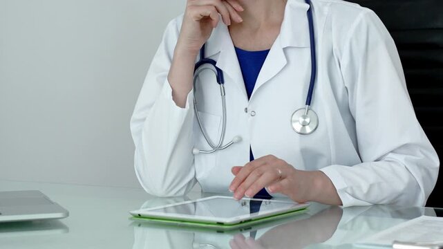 Medical professional using digital tablet, leveraging modern technology for patient care and health consultation, researching crucial information, and managing medical records