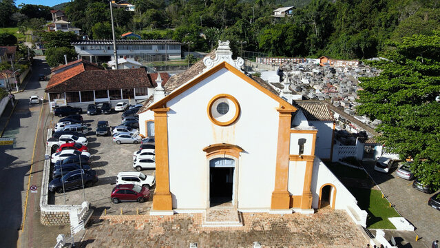 Frontal drone view of the historic colonial church of Nossa Senhora das Necessidades in Santo Antonio de Lisboa, Florianopolis, Brazil.
