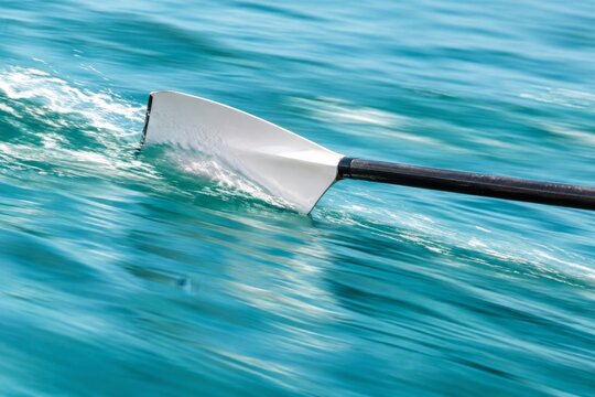Rowing Oar Cutting Through Blue Water