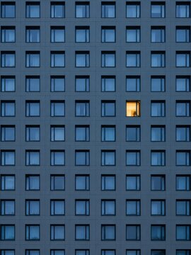 Single Lit Window in Repeating Facade