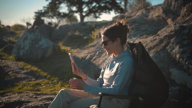 Young Latina woman sitting in a park using her smartphone before putting it aside to relax, representing digital detox, mindfulness, outdoor leisure, and work-life balance.
