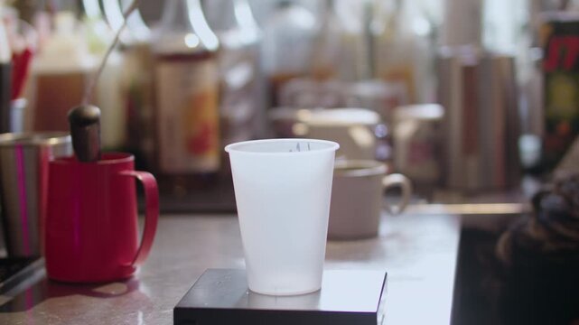 Empty Takeaway Cup on Scale at Cafe Counter