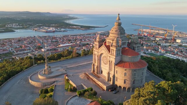 Wide drone orbit around the Sanctuary of Santa Luzia during the golden hour in Portugal. orbit, orbiting, parallax