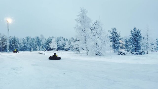 People Driving Go Karts in Snow at Santa Claus Village Lapland Finland