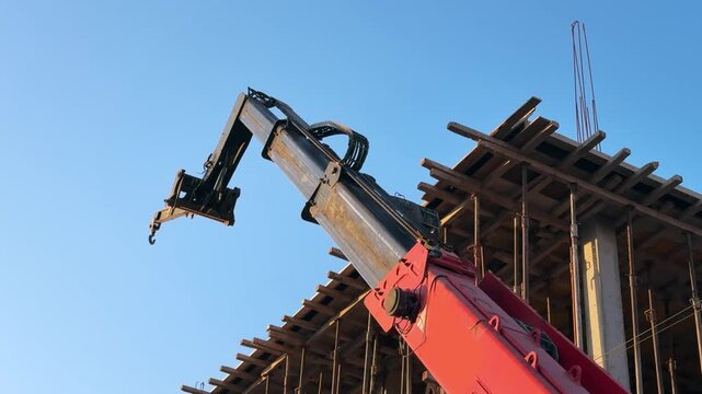 Industrial Crane Arm at Building Construction Site Under Blue Sky