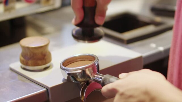 Tamping Ground Coffee in Portafilter for Espresso
